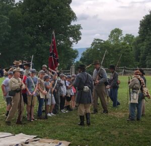 Living historians demonstrate a regimental line up to children's Civil War camp participants.